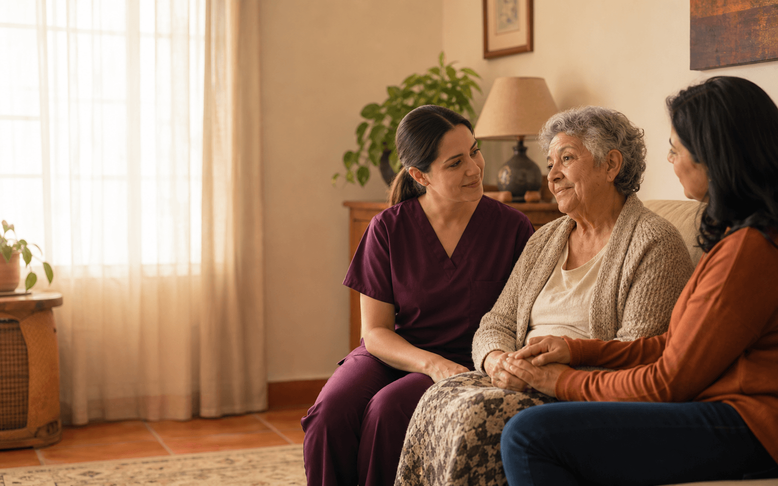 Hospice nurse talking warmly with a family and an older adult at home